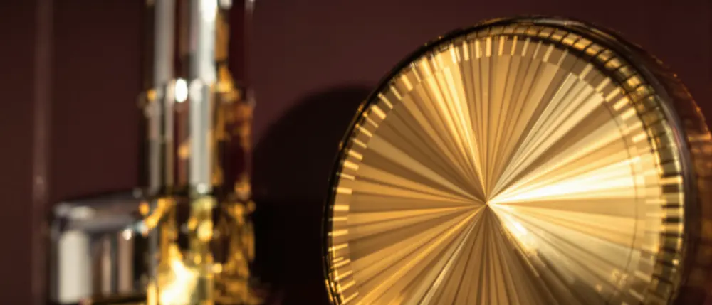 A brass art deco safe dial set into a plum lacquered door